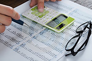 Person Hands Analyzing Accounting Document