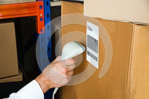 Person Hands With Barcode Scanner Scanning Box