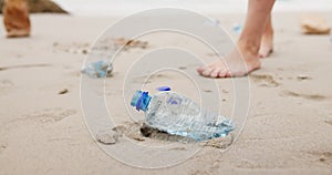 Person, hands and beach with plastic bottle for recycling, cleaning or saving the planet in nature. Closeup of volunteer