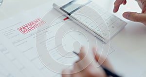 Person, hands and calculator with documents in payment, debt or financial crisis on table at home. Closeup of accountant