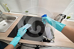 Person hands cleaning induction stove