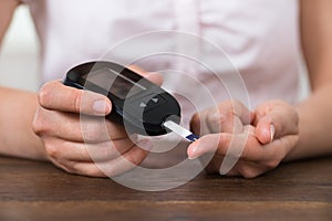 Person Hands Holding Glucometer