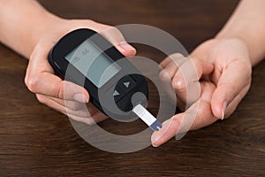Person Hands Holding Glucometer