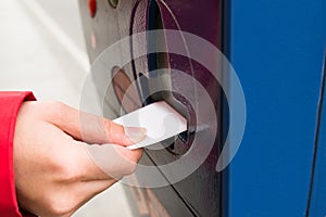 Person Hands Inserting Ticket Into Parking Machine