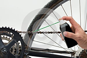 Person Hands Lubricating Bike photo