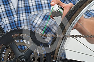 Person Hands Lubricating Bike photo