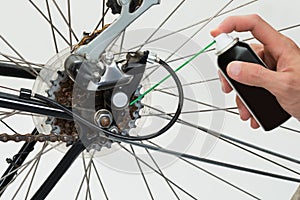 Person Hands Lubricating Bike photo