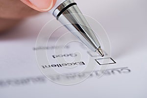 Person hands with pen over customer survey form