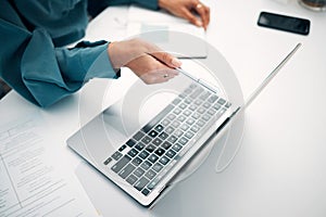Person, hands and pointing to laptop with documents in finance, budget planning or investments on office desk. Closeup
