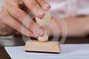 Person hands stamping document