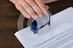 Person Hands Stamping Document