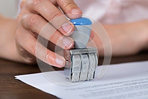 Person Hands Stamping Paper