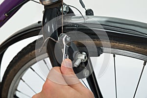 Person Hands Tightening Bolt Of Bicycle Tire