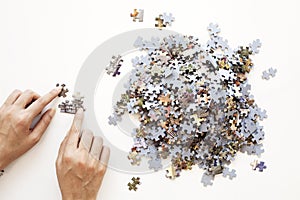 Person hands Unfinished color puzzle pieces on white background. Business concept