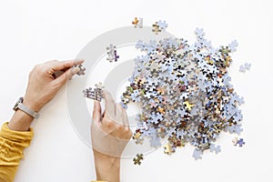 Person hands Unfinished color puzzle pieces on white background. Business concept