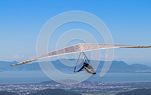 Person hang gliding over a coastal area