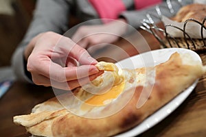 Person has Adjarian Khachapuri