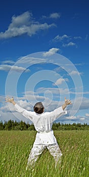 Person has lifted hands to blue sky - happiness photo