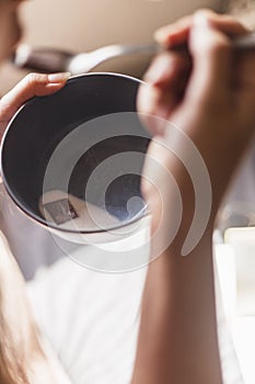 Person having breakfast in cereals in bed in the morning