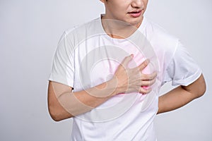 A person having a heart attack. Young asian man had chest pain and held his hand on his chest