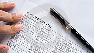 Person health check list paper with hand photo