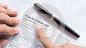 Person health check list paper with hand photo