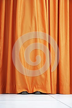 Person Hiding Behind Orange Curtain