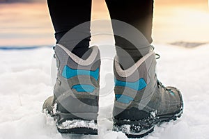 Person hiking on the mountaintop covered with snow