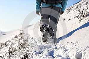 Person hiking on the mountaintop covered with snow low angle view