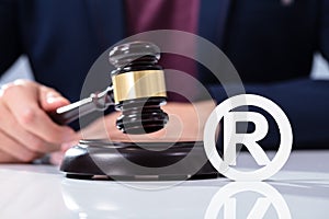 Person Hitting The Gavel Near Trademark Icon