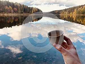 Person hold a cup with hot tea