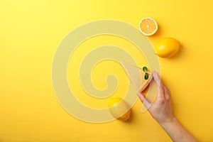 Person hold slice of lemon tart on background, top view