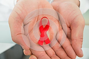 Person holding aids ribbon