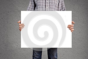 Person holding blank white banner with copy space