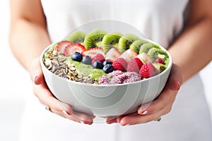 A Person Holding A Bowl Of Fruit And Cereal