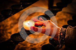 person holding a candle in church