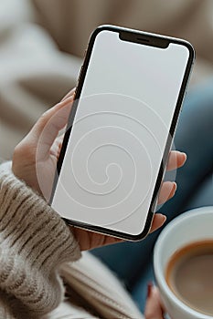 A person holding a cell phone with a white screen