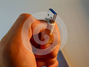 Person holding computer hard drive USB stick in their hand