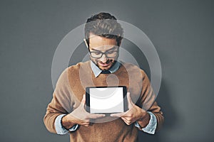 Person holding copyspace, blank and empty tablet screen with an internet app in studio against a grey background