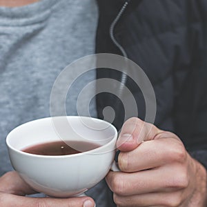 Person holding cup of coffee