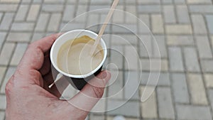 Person holding cup of coffee and walk