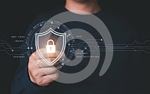 Person holding digital shield with padlock and binary code digital security protection