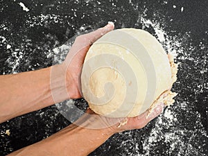Person holding a dough after proofing photo