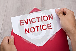 Person Holding Eviction Notice In Envelope