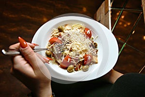 Person Holding Fork and Bowl of Food