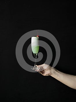 a person holding a glass of red wine photo