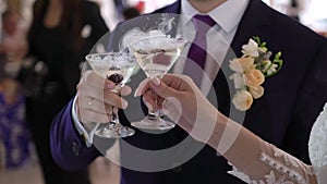 Person holding glass of wine or champagne or other alcohol drink in hand at the party.