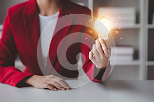 Person holding glowing lamp, Creative new idea. Innovation, brainstorming, strategizing to make the business grow and be