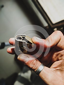 A person holding a golden lighter in his hand photo