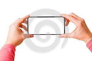 Person holding in hands smartphone with blank screen and taking picture or recording video, isolated on white background